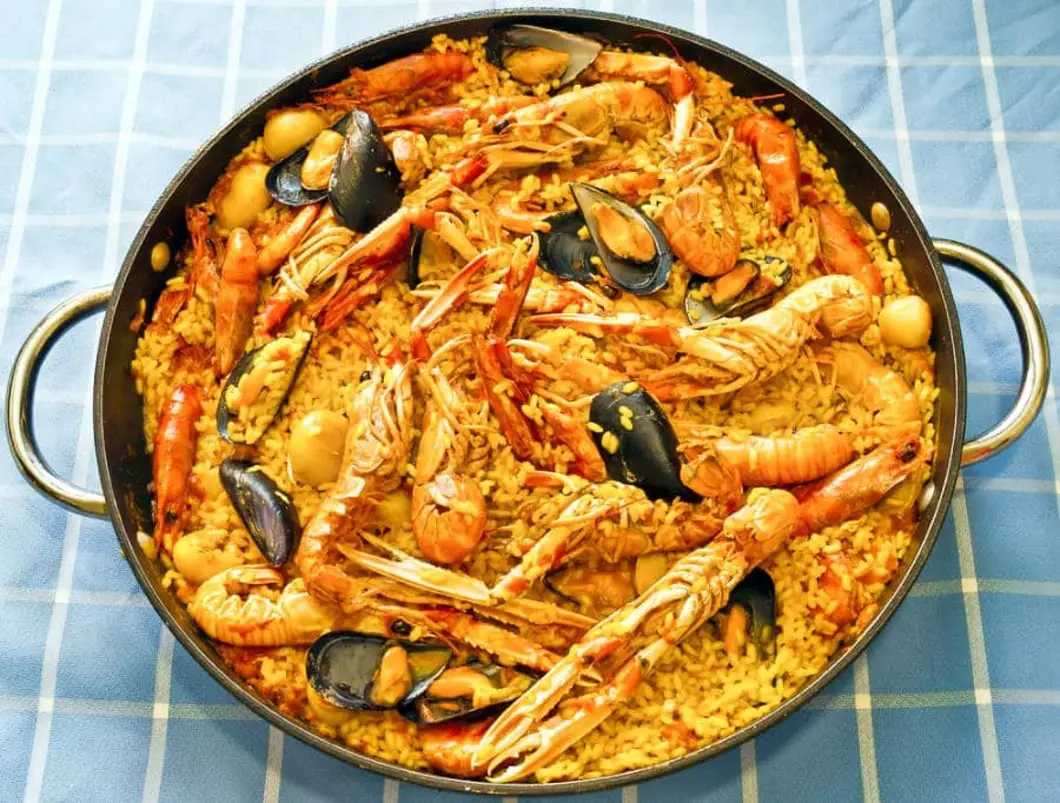 Image of traditional Valencian paella with seafood at Casa Carmela restaurant