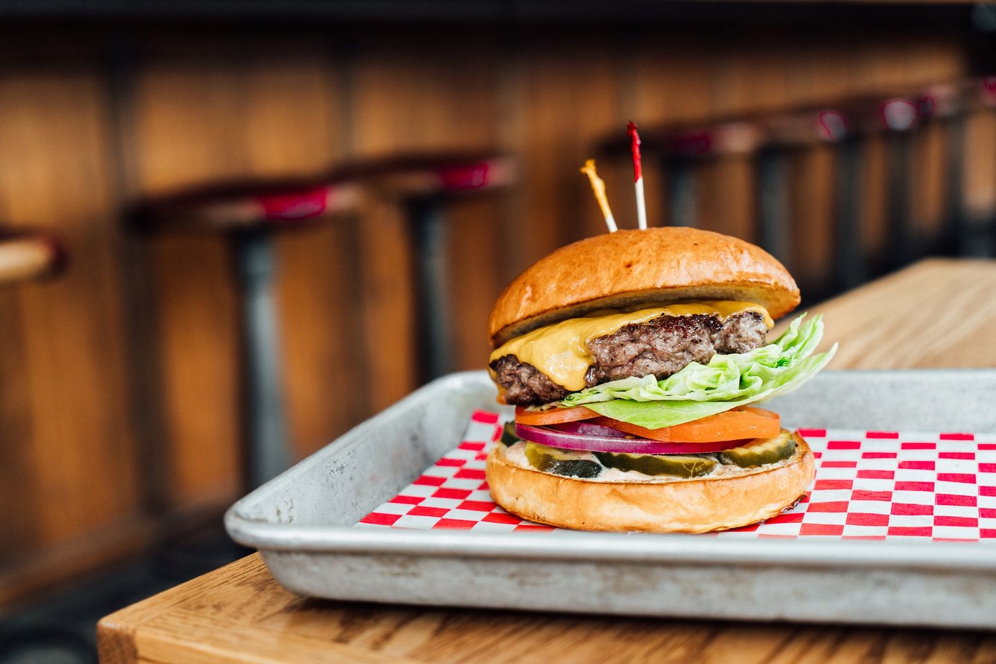 Image of a burger at the table at Cassell's Hamburgers