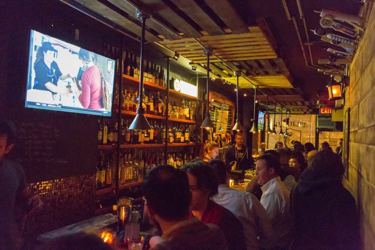 People socializing inside the The Jeffrey Bar