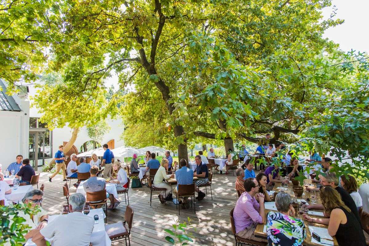 Image of people sitting at Rust en Vrede Wine Estate