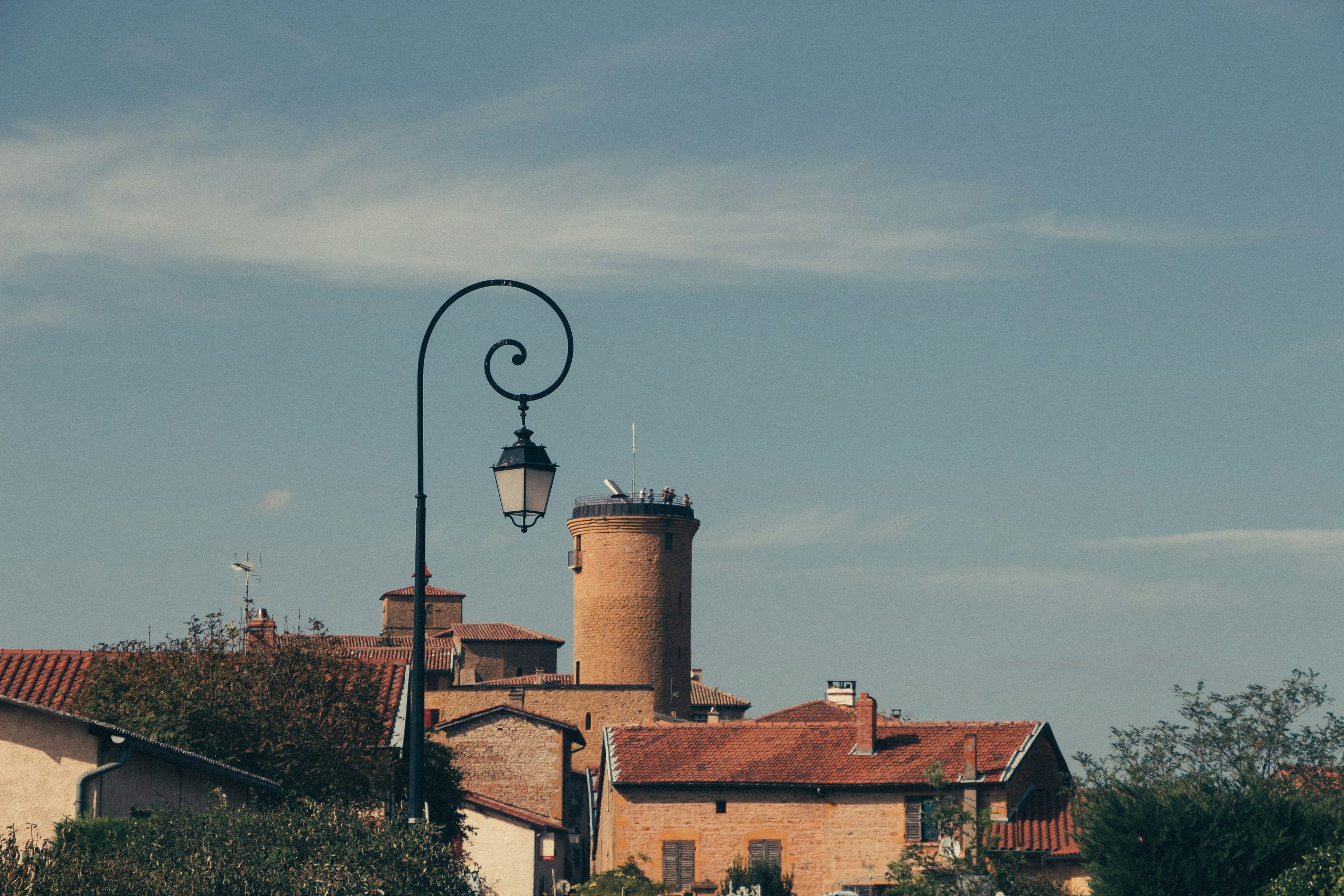 lamppost near buildings during day in Village d'Oingt